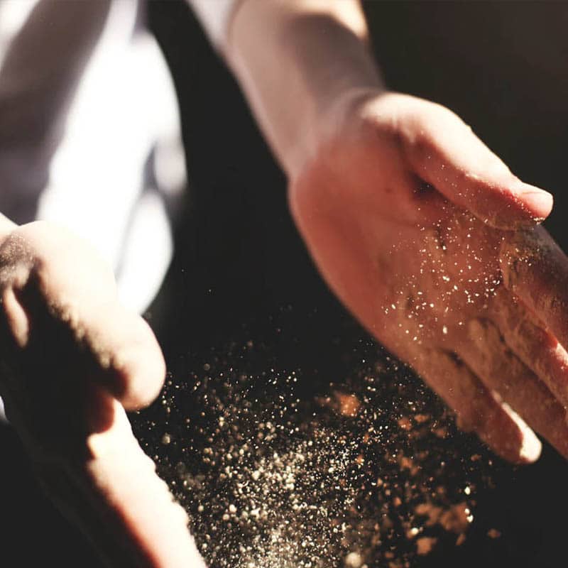Closeup of working hands clapping dust or food from them