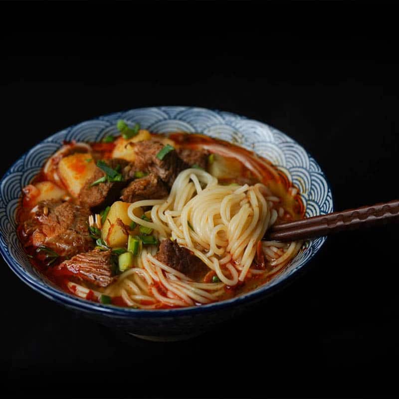 Closeup restaurant product photo of a bowl of pho noodles